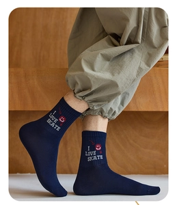 Detail of navy blue crew sock featuring I LOVE SKATE text and red smile graphic