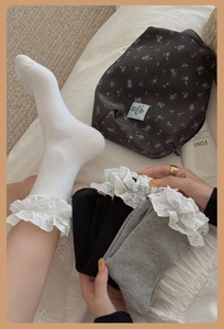 Detailed texture of cotton lace trim socks in white, black and grey set