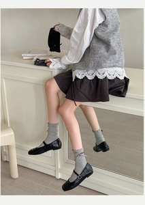 Detail of sweet ruffle cuffs and ribbon bows on mid-tube socks with Mary Jane shoes