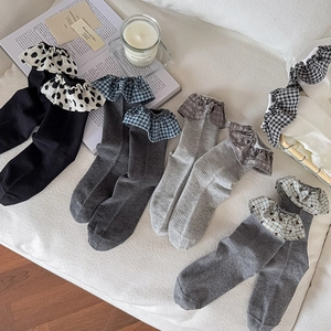 Lace ruffle cuff crew socks in assorted plaid and polka dot patterns on white background