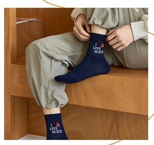 Close-up of navy crew socks with red smiley face and I LOVE SKATE letter embroidery