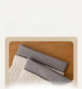 Detailed macro view of the elastic ribbed cuffs on gray and beige men's sports socks