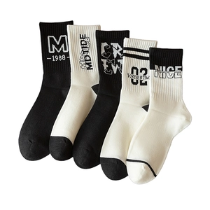 Five-pair pack of black and white athletic crew socks with letter embroidery and sporty design