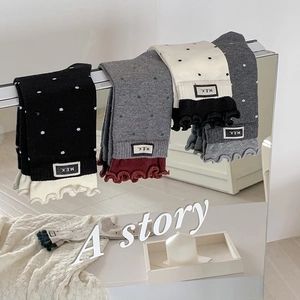 Polka dot crew socks with ruffle cuffs and letter patch in black grey and cream