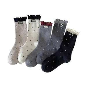 Five pairs of polka dot crew socks for women featuring ruffle cuffs and M.E.K. cloth labels