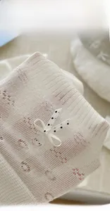 Detail of knit socks with bow and Hello Kitty resin accessory for balletcore style