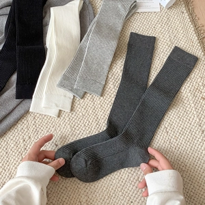 Minimalist ribbed knit knee high socks for women in multiple neutral colors with elastic fit