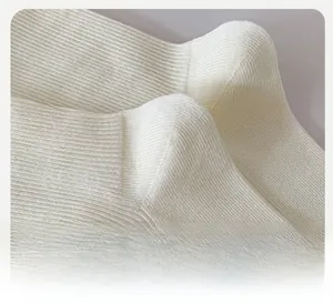 Detail view of the ribbed knit heel construction on cream white mid-calf socks
