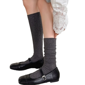 Dark grey ribbed knit crew socks styled with black leather Mary Jane shoes