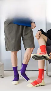 Detail of professional athletic socks featuring non-slip silicone pads on the sole for grip