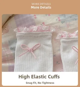 Detail of elastic white socks with pink ruffle trim and a delicate bow decoration