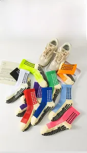 Flat lay of colorful anti-slip soccer socks with silicone grip pads in various colors