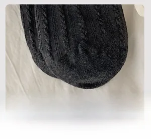 Macro shot of smooth seamless toe stitching and dense knit texture on black cotton socks