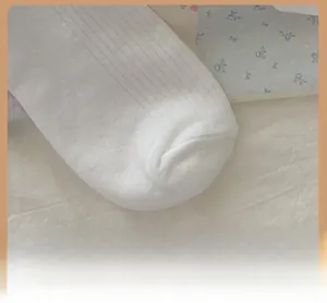 Close-up of reinforced toe and ribbed knit texture on white cotton bow socks
