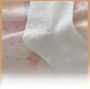 Close-up of the comfortable heel stitching and ribbed knit texture of white cotton socks