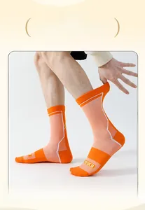 Detail of the high-elastic wide cuff on orange professional cycling socks with mesh texture