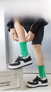 Detail of high-elastic ribbed cuffs on bright green soccer socks with grid texture