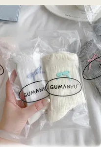 Detail of sweet bow mesh socks in various colors with elegant transparent packaging
