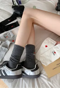 Detail of red heart embroidery and I Love Paris text on gray cotton mid-calf socks