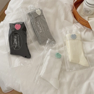 Women's knit mid-calf socks with crochet heart detail in black, grey, white and beige colors