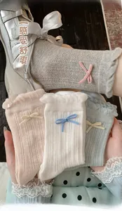 Detail of sweet ruffle cuffs and tiny bowknots on breathable hollow-out crew socks
