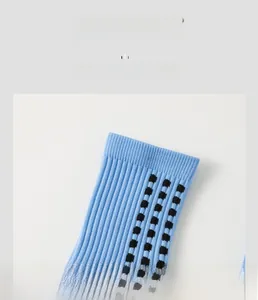 Detail of high-elasticity ribbed cuff on blue sports socks with black square pattern