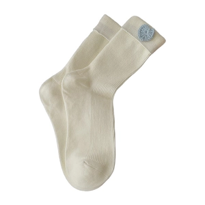 Beige cotton knitted mid-tube socks featuring blue crocheted heart patches on a white background
