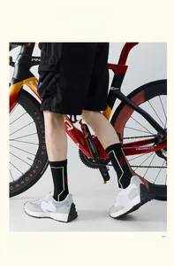 Detail of cycling socks on feet with neon green lines and red claw patterns