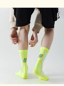 Close-up of fluorescent yellow sports socks with ribbed cuffs and breathable mesh texture