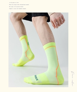 Detail of neon cycling socks featuring breathable mesh fabric and SPEOCR branding logo