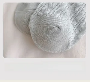 Macro detail of seamless toe stitching and breathable mesh texture on the knit socks