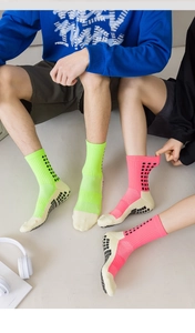 Close-up of anti-slip silicone grip pads on professional sports socks in neon colors