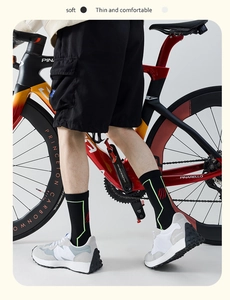 Detailed view of breathable black cycling socks with neon green and red athletic patterns