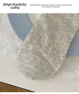 Detail of high-elastic grey ribbed knit sock cuff with textured stripe pattern