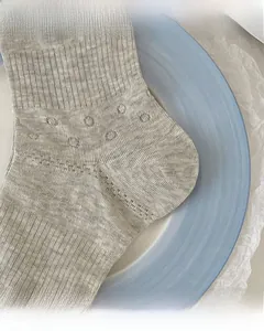 Detail of reinforced toe and heel on grey knitted cotton socks with mesh texture
