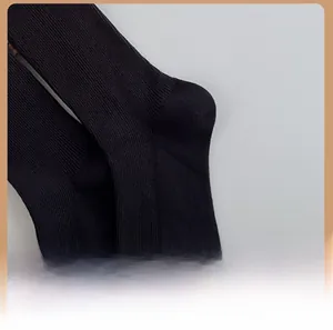 Detail shot of the reinforced ergonomic heel on a black rib-knit ballet style cotton sock