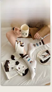 Close-up of knit cotton socks with cartoon dog prints and I'm ok text on the sole