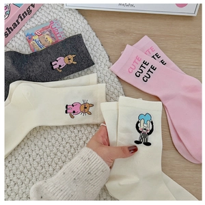 Detail showing cute cat and rabbit embroidery on cotton crew socks in neutral colors