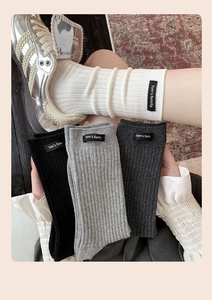 Detail of ribbed knit crew socks with 'Tom's family' woven label in four classic colors
