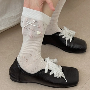 Sweet balletcore white mesh crew socks with bows and heart charms worn with black shoes
