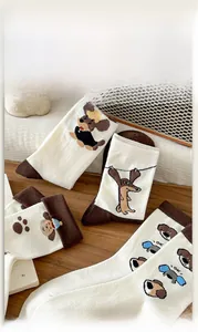 Close-up of retro brown cartoon dachshund cotton socks on a wooden table setup