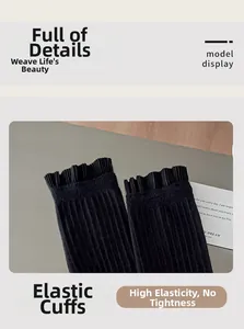 Detail view of black ribbed crew socks featuring delicate ruffled cuffs and high elasticity
