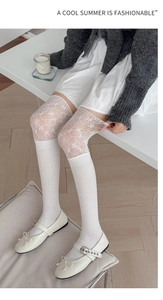 Gros plan de chaussettes montantes blanches avec dentelle et tricot à rayures verticales