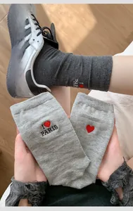 Detail of gray cotton socks featuring red heart embroidery and I Love Paris text