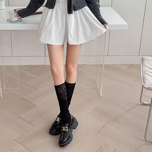 Black ballet lace calf socks with glossy leather loafers featuring a golden buckle detail