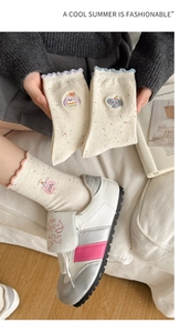 Detailed view of women's flecked cotton socks with animal embroidery and ruffled cuffs