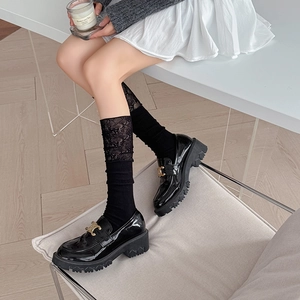 Ballet style lace trim calf socks paired with black patent leather platform loafers