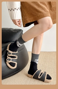 Close-up of cute koala embroidery on grey and black spliced mid-calf socks