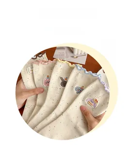 Detail of colorful ruffled cuffs and cute animal embroidery on spotted cotton socks