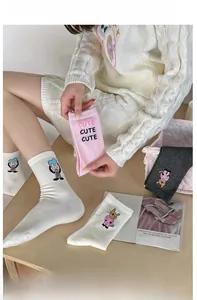Detail of cute embroidered cat and rabbit patterns on rib-knit cotton crew socks